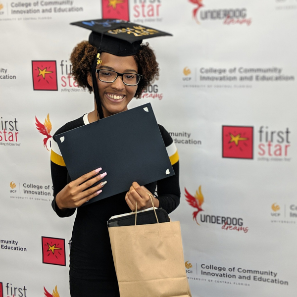 First Star Alumni holding diploma 