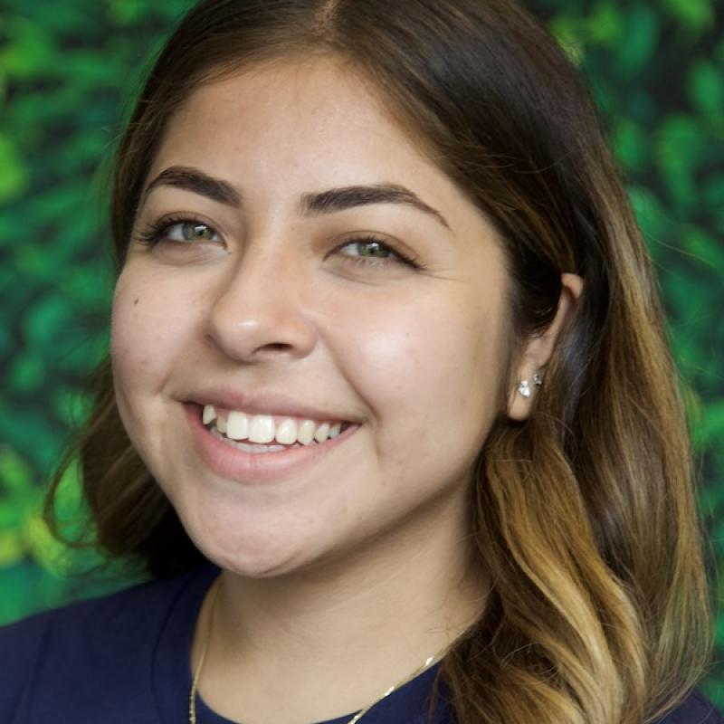 A photo of Kayla Murillo with a green background.